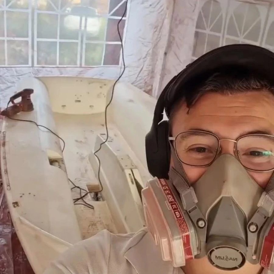 Luis restoring a boat hull