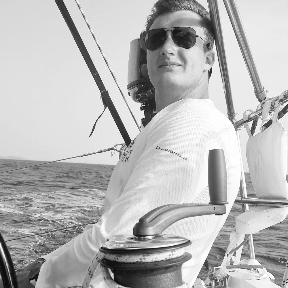 Luis at the helm of a sailboat